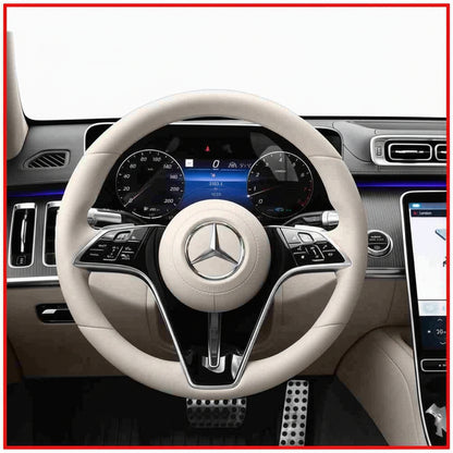 Car steering wheel with Mercedes-Benz logo in a vehicle interior