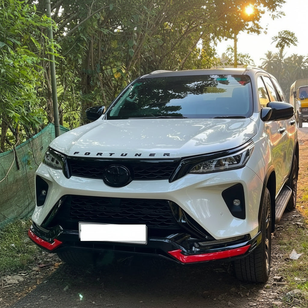 White Toyota Fortuner SUV parked on a road with trees in the background