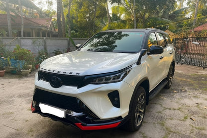 White SUV with black and red accents parked on a driveway