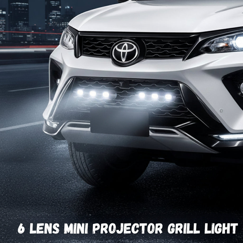 Front view of a Toyota Fortuner Legender car with a 6 lens mini projector grill light on a dark background.