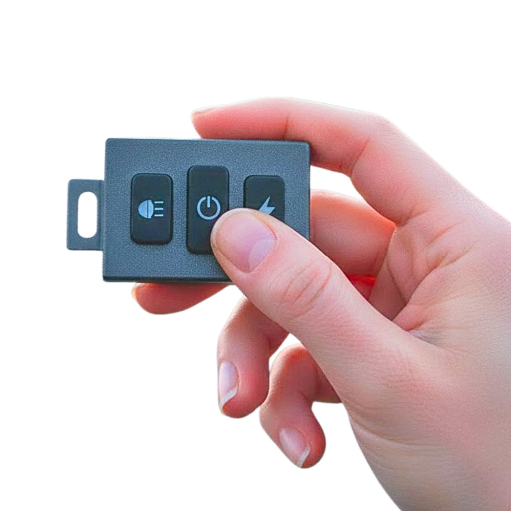 Hand holding a small electronic device with buttons on a white background