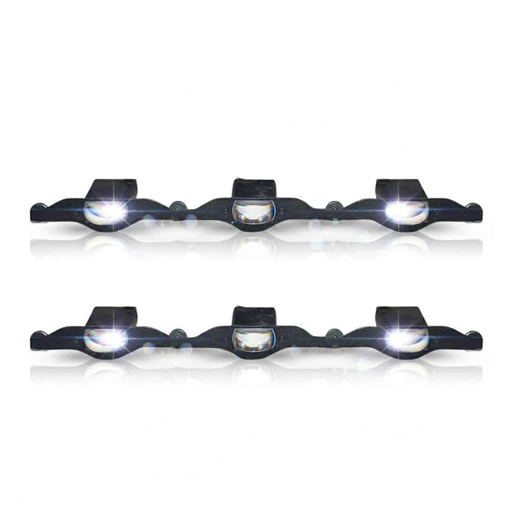Set of four black bike lights with white lenses on a white background