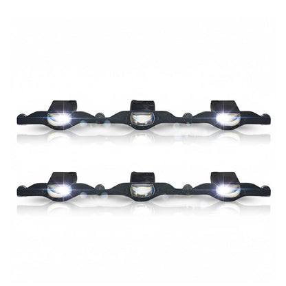 Set of four black bike lights with white lenses on a white background
