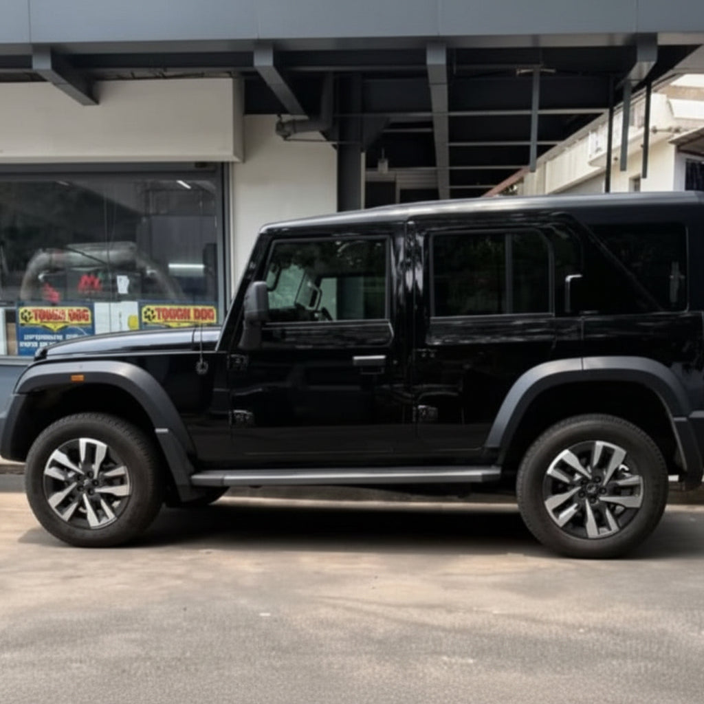 A black SUV parked on a street with tough dog suspension installed.