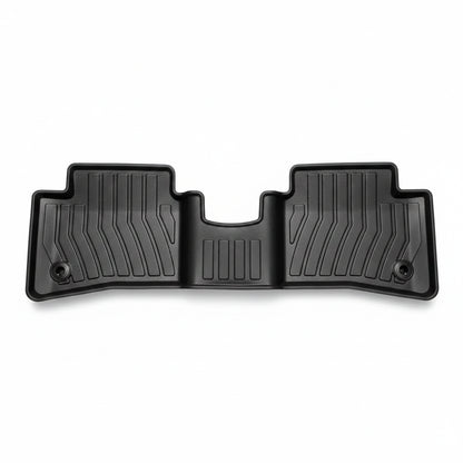 Black car floor mat with textured design on a white background