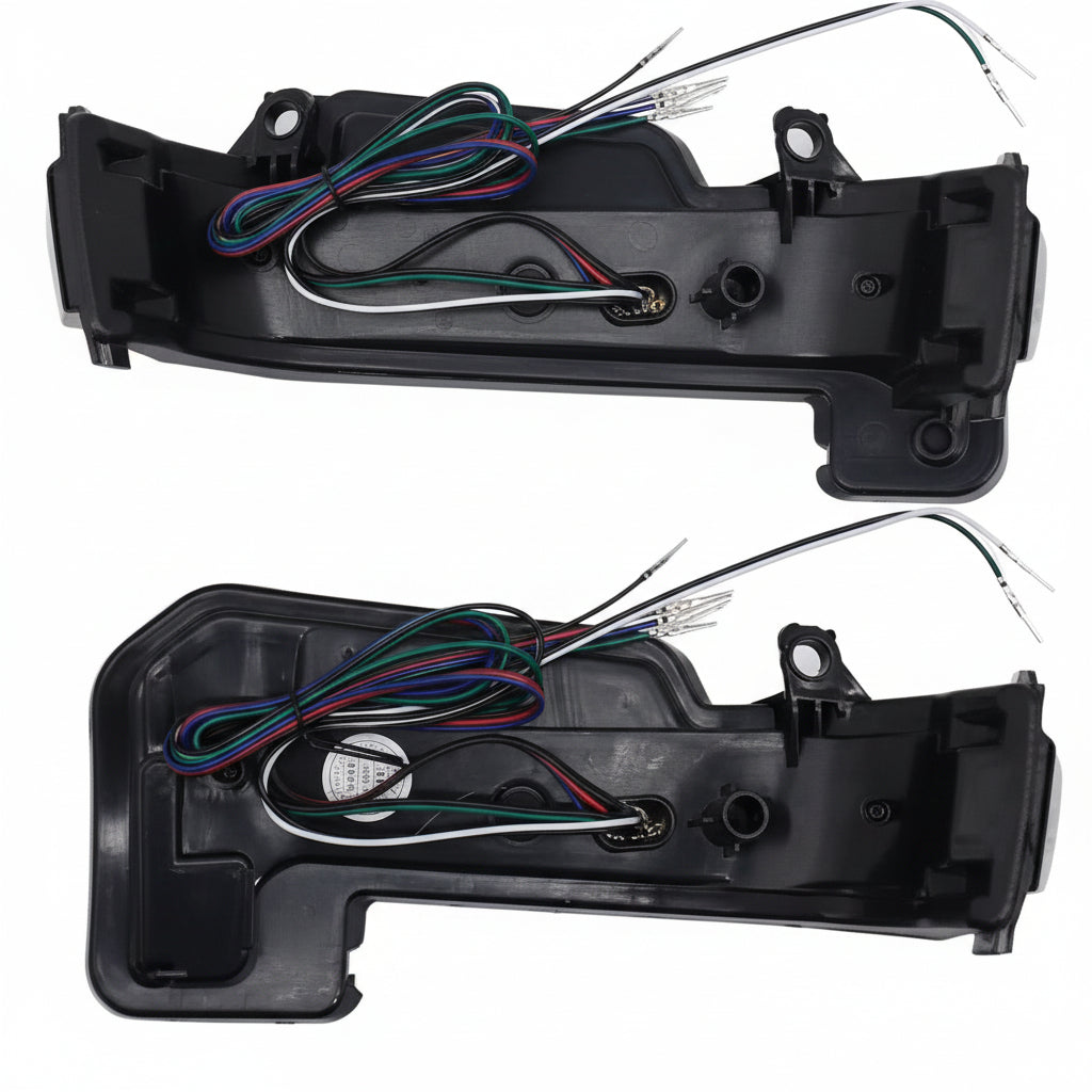 Two car ORVM indicator assemblies with wiring on a white background