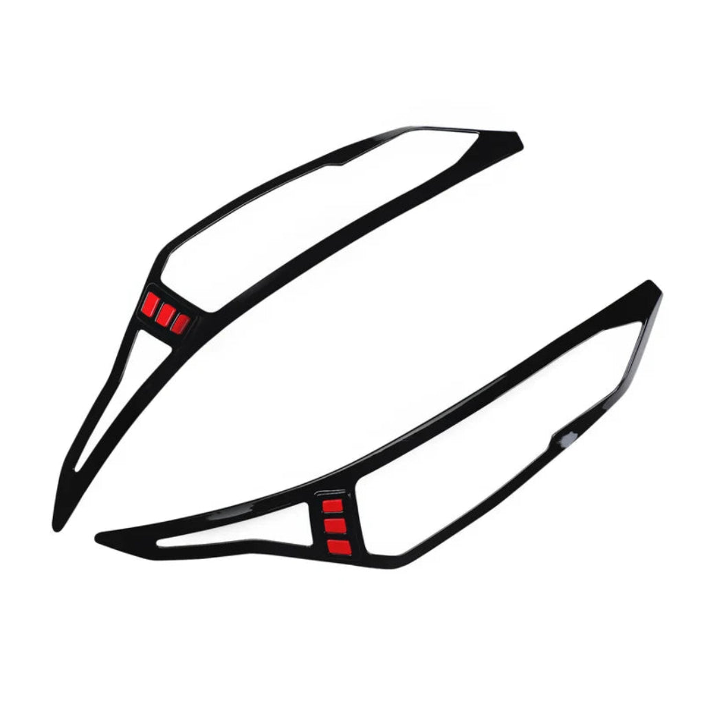 Set of 2 black headlight covers for Magnite, displayed on a white background. 