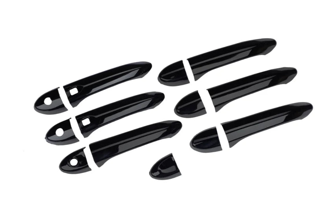 Set of black door handle covers for Nexon, displayed on a white background. 