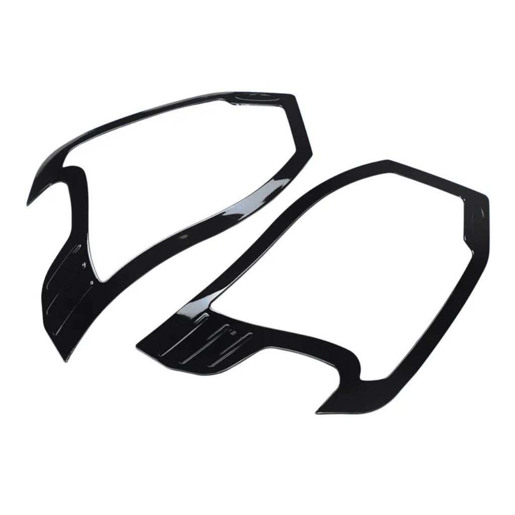 Black HeadLamp Garnish/cover for Wagon-R placed on a white background. 