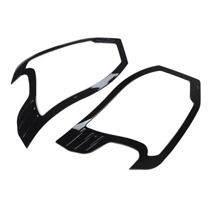 Black HeadLamp Garnish/cover for Wagon-R placed on a white background. 