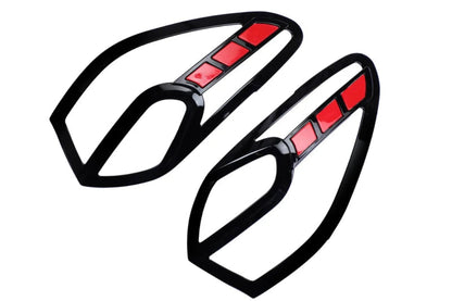A pair of black appliqués for tailights with red reflective sections, for I20 Nios, shown on a plain white background.