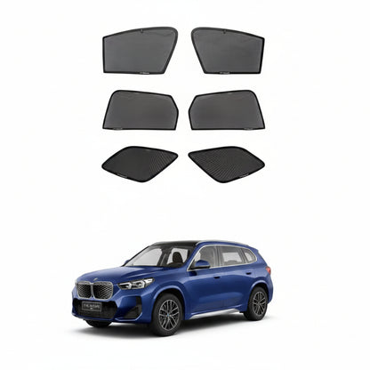 Set of car window sunshades for BMW X1 LWB with a blue SUV in the background