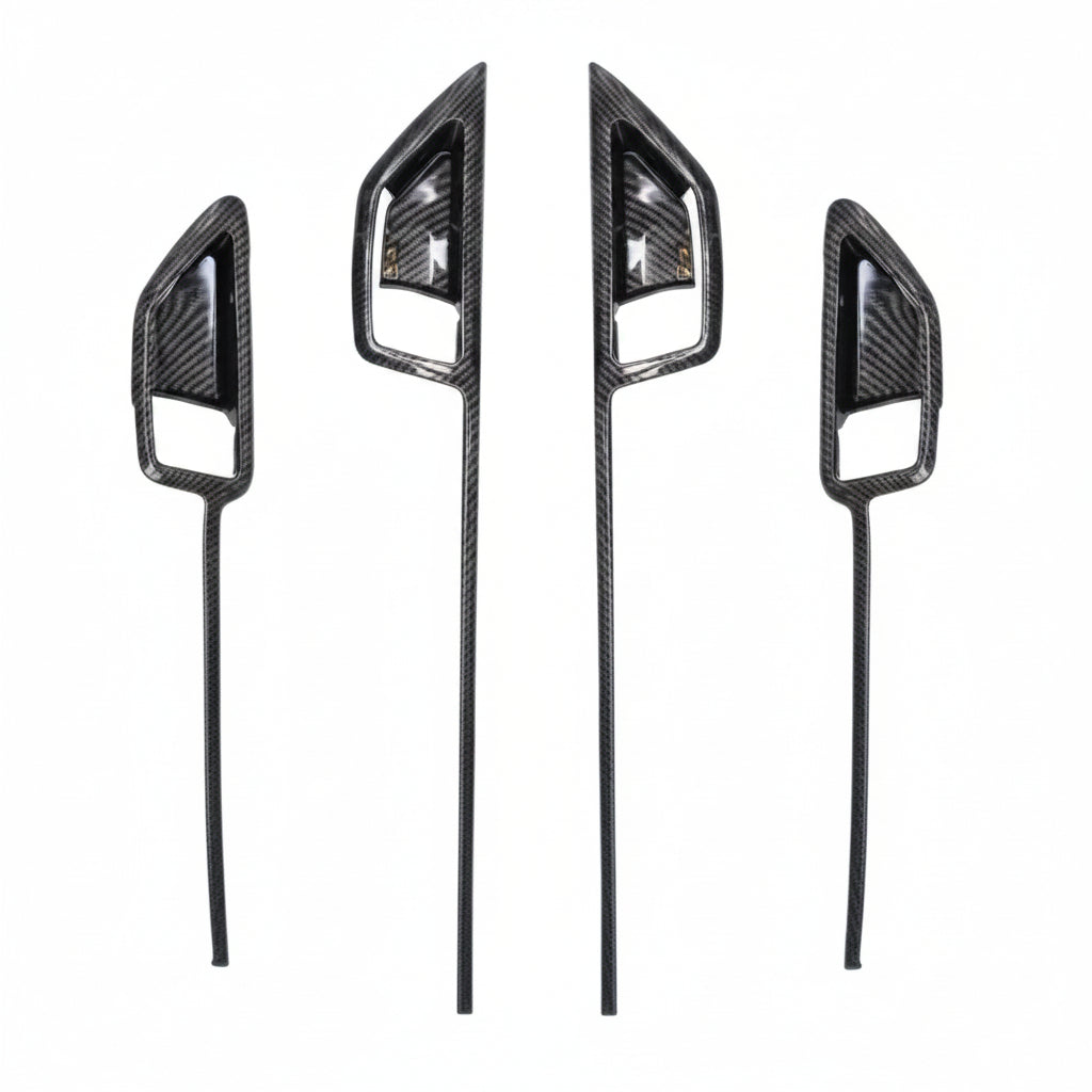 Four carbon fibre door trims on a white background