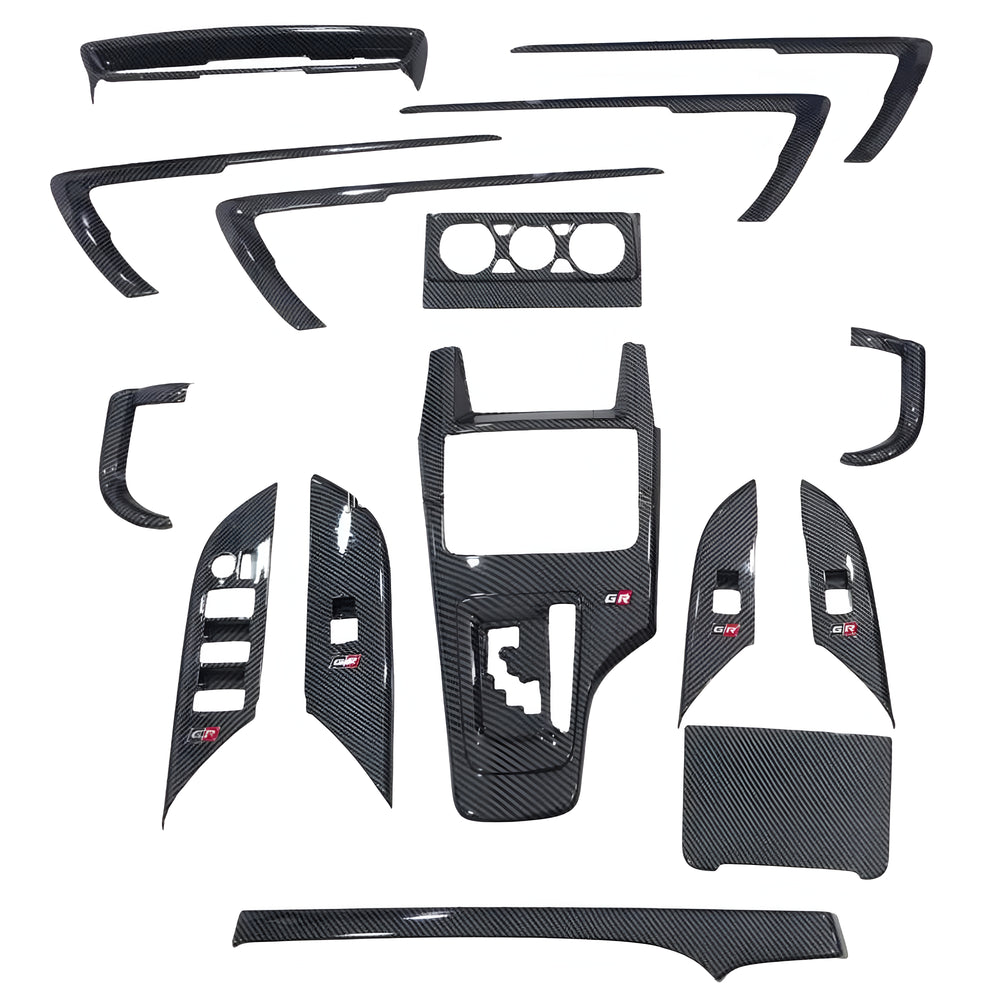 Set of carbon fiber car interior panels on a white background
