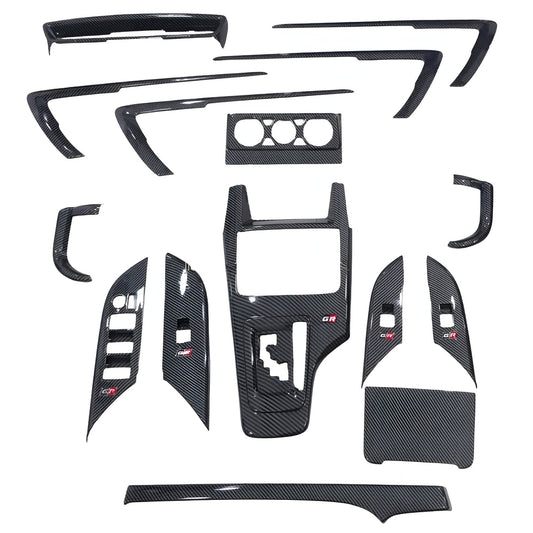 Set of carbon fiber car interior panels on a white background
