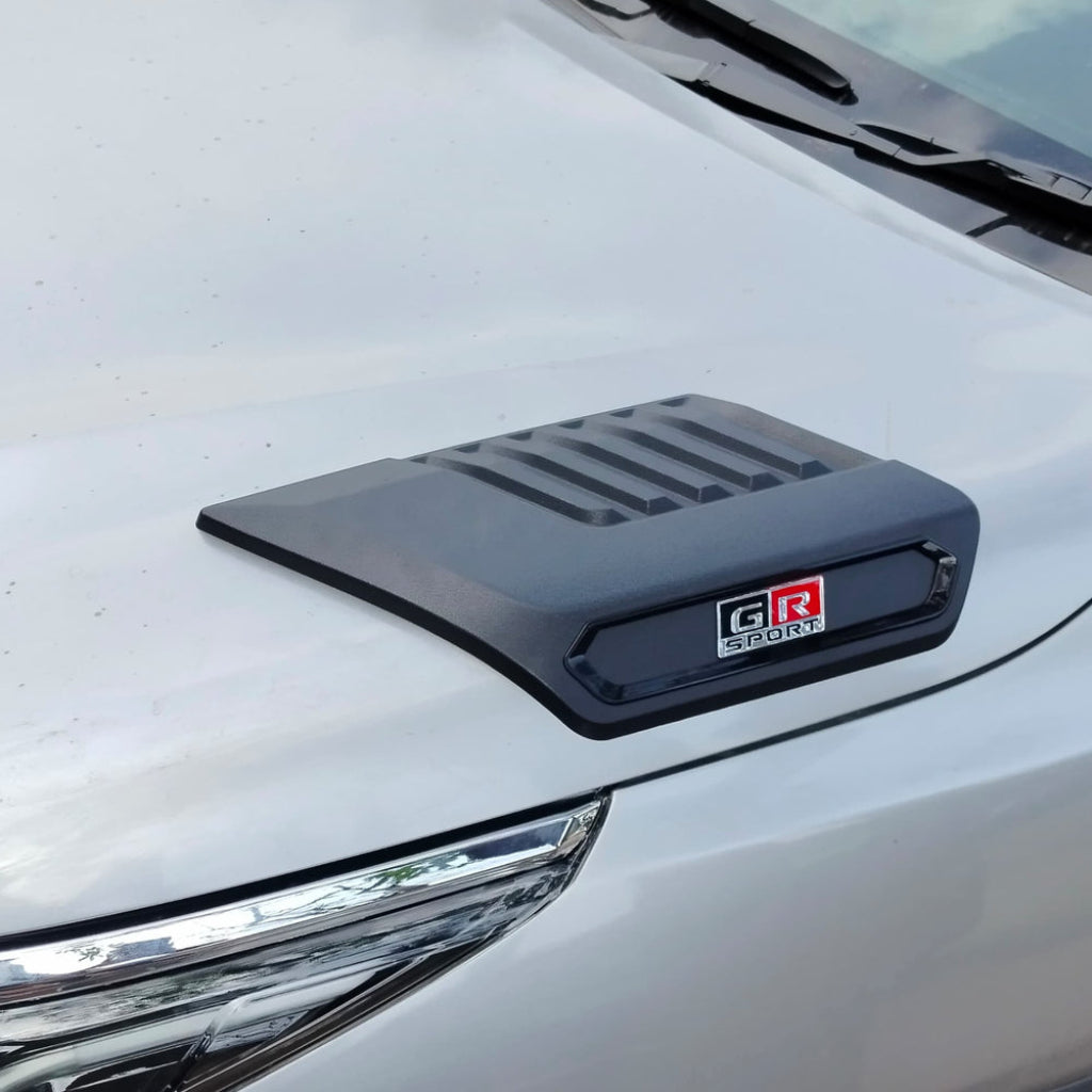 Car hood scoop with 'GR Sport' logo on a white car