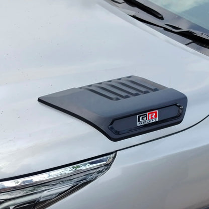Car hood scoop with 'GR Sport' logo on a white car