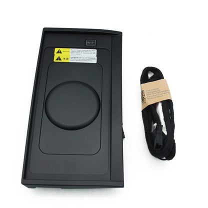Black electronic device with a cable on a white background