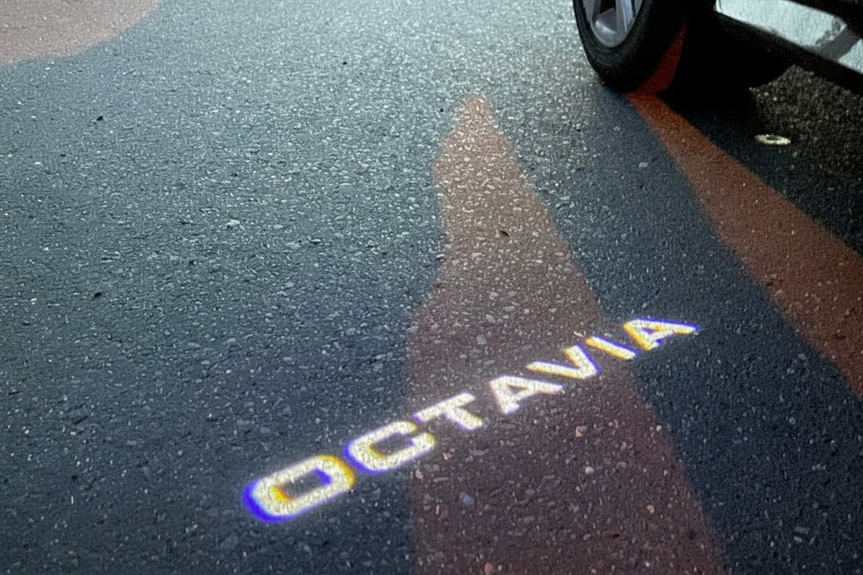 Shadow of a car on a road with 'Octavia' branding.