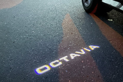 Shadow of a car on a road with 'Octavia' branding.