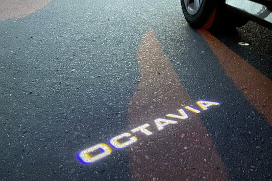 Shadow of a car on a road with 'Octavia' branding.
