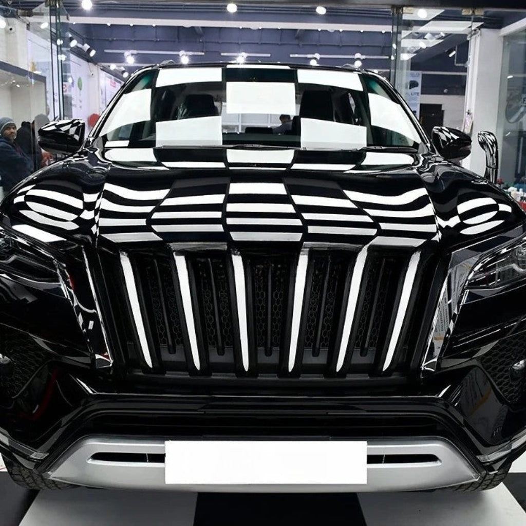 Black SUV with a checkered pattern on a showroom floor