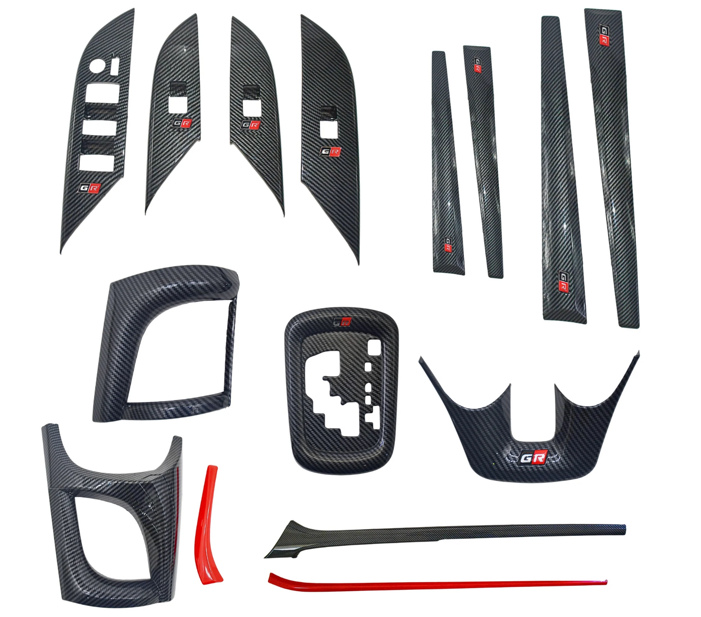 Set of carbon fiber car interior trim pieces on a white background