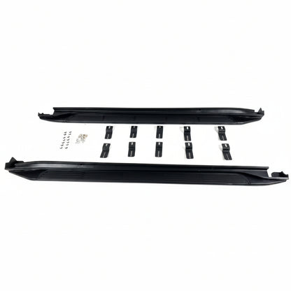 Black side steps for a car with mounting brackets on a white background