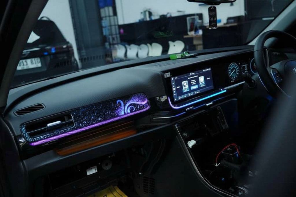 Car interior with dashboard lights and a visible steering wheel.