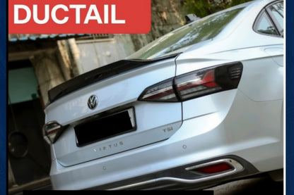 Silver car with 'DUCTTAIL' branding on a blurred background