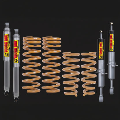 Tough Dog suspension components including shock absorbers and springs on a black background