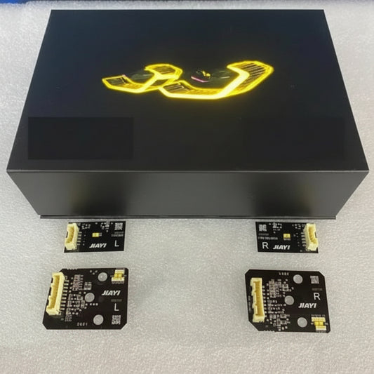 Black electronic box with yellow logo on a light gray surface