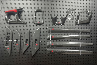 Carbon fiber car parts on a pegboard