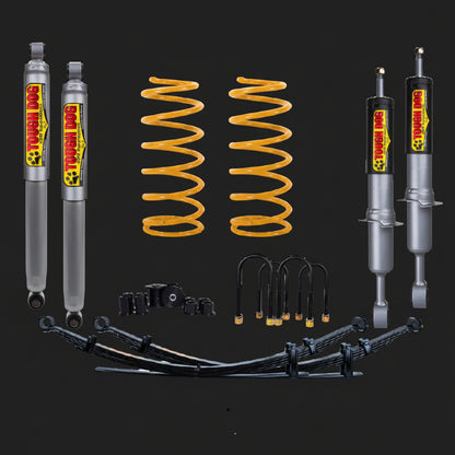 Automotive suspension components including shock absorbers and springs on a black background with 'Bushings' branding.