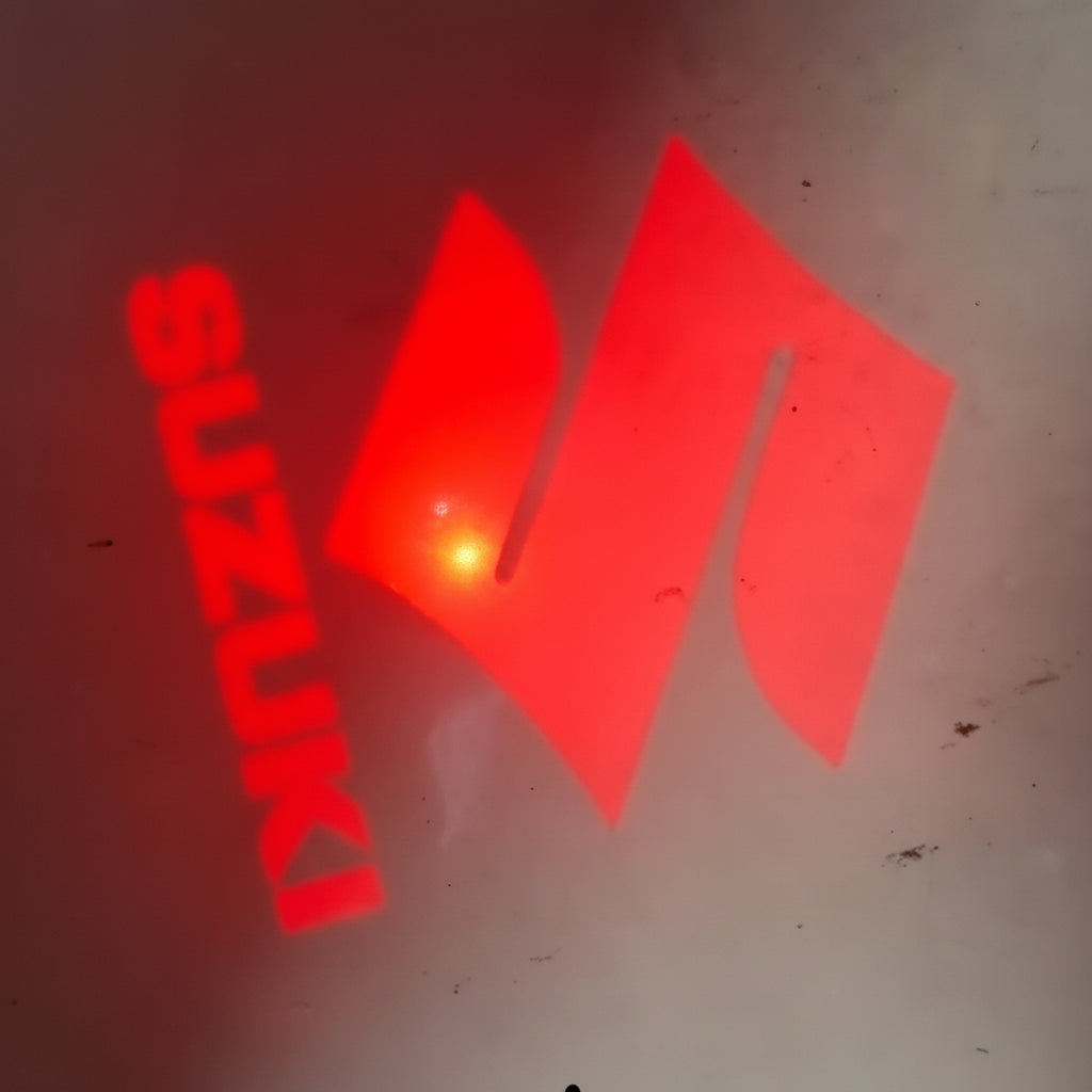 Red Suzuki logo on a dark background