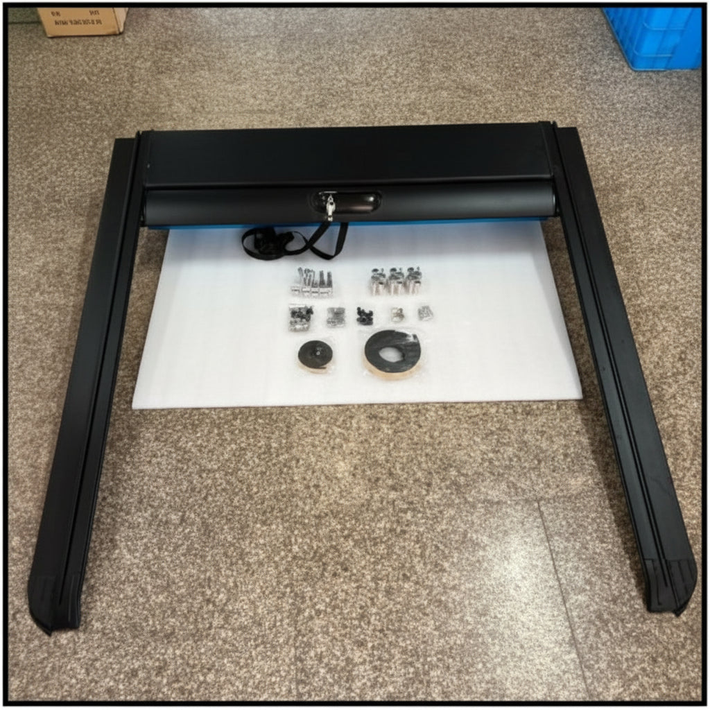 Black metal frame on a white mat with small components on a beige carpeted floor.