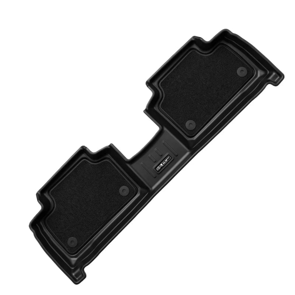 A black molded automotive floor mat shown on a plain white background, photographed from an angled overhead perspective. The mat features two textured rectangular sections and a central handle grip.
