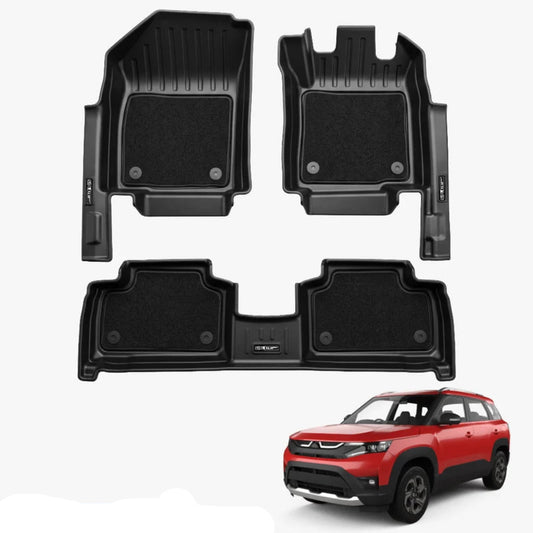 Three-piece black car floor mat set including two front footwells, two rear footwells, and a trunk liner, shown on a light grey background with a red Brezza SUV in the bottom right corner and a blue text label reading BREZZA 2022+ XLMGRIP.