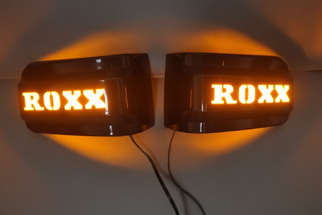 Two amber LED lights with 'ROXX' branding on a dark background