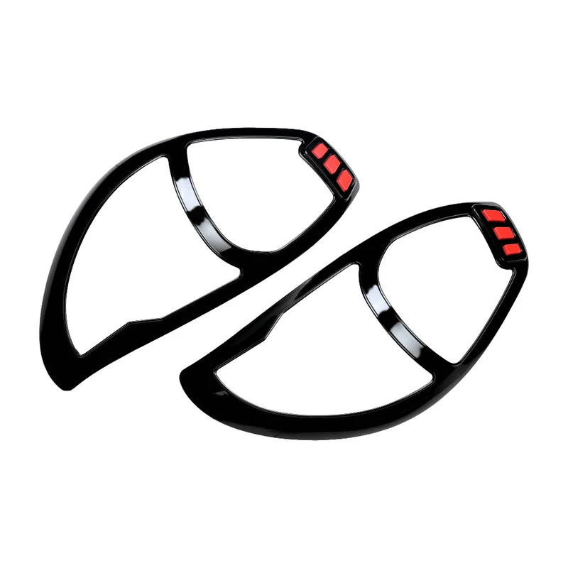 A pair of hybrid black head light garnishe for Alto 800 on a white background. 