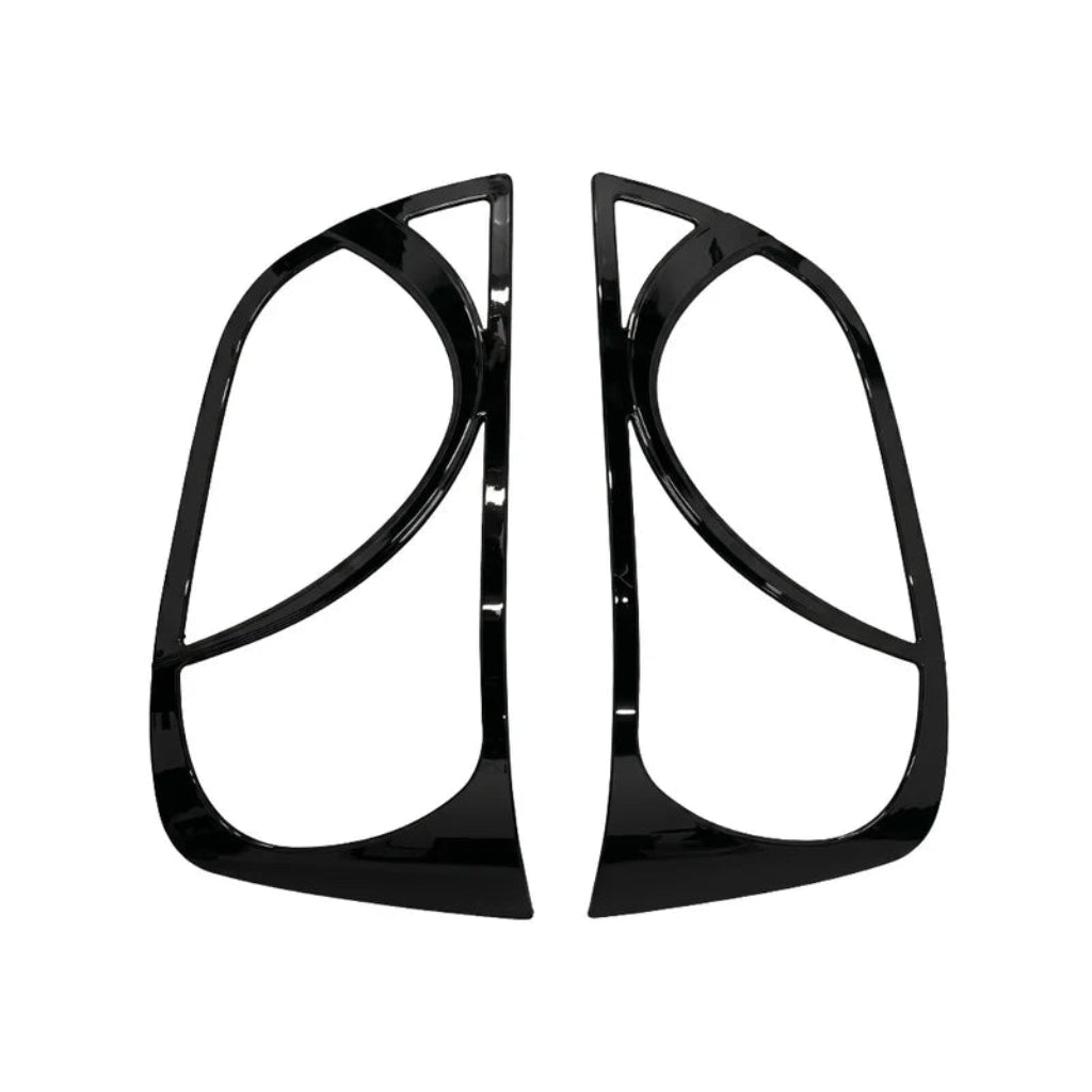 A pair of glossy black headlight covers, shown on a plain white background.