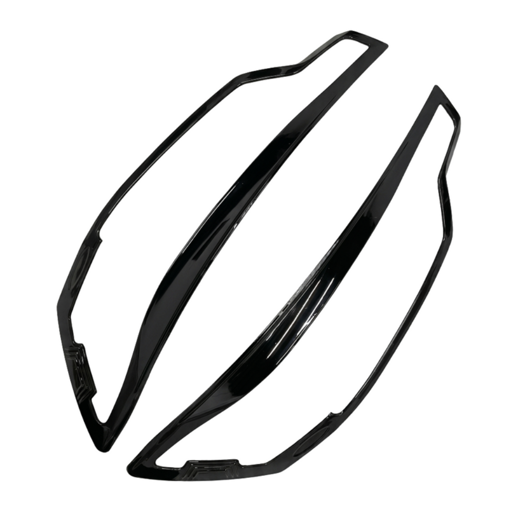 Set of 2 pcs black headlight covers for Ertiga, displayed on a white background. 