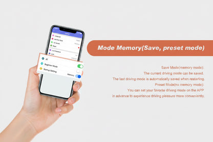 A hand holds a smartphone showing a driving app interface with a mode memory toggle turned on, alongside text explaining that the current driving mode can be saved and preset mode memory models can be set in advance.