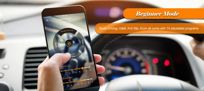 A hand holds a smartphone displaying a driving training app interface inside a car, with the dashboard, steering wheel, and speedometer blurred in the background. Orange text banners read 'Beginner Mode' and describe adjustable programs.